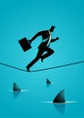 Businessman running on rope with sharks underneath Royalty Free Stock Photo