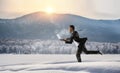 Businessman running in winter countryside . Mixed media Royalty Free Stock Photo