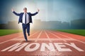 The businessman running towards money on track Royalty Free Stock Photo