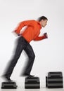 Businessman running up with dumbbells Royalty Free Stock Photo