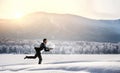 Businessman running in winter countryside Royalty Free Stock Photo