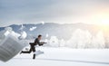 Businessman running in winter countryside Royalty Free Stock Photo