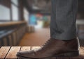 Businessman's foot and shoe on wood