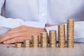 Businessman's Hand Behind Euro Coins At Desk Royalty Free Stock Photo