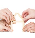 Businessman's hand building house by wooden block