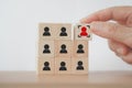 Hand choose red person and focus sign on wooden cube block for human resource, leadership concept Royalty Free Stock Photo