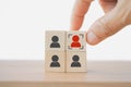 Hand choose red person and focus sign on wooden cube block for human resource, outstanding leadership concept Royalty Free Stock Photo