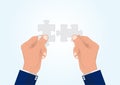 Businessman`s hand connecting two puzzle pieces jigsaw together,successful solution business concept