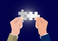 Businessman`s hand connecting two puzzle pieces jigsaw together,successful solution business concept