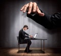 Businessman's hand controlling a worker marionette Royalty Free Stock Photo