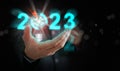 Businessman`s hand holding the year 2023 with light blub, dart, and target. Starting new year, business, project, path, goal, or Royalty Free Stock Photo