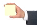 Businessman's Hand Holding Yellow Post-It