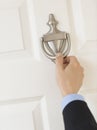 Businessman'S Hand Knocking Door Handle Royalty Free Stock Photo