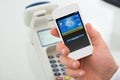 Businessman's hand paying through mobilephone