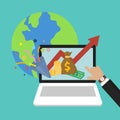 Businessman`s hand pointing at money profits and global economy world savings on laptop, computer symbol