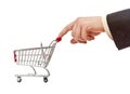 Businessman's hand pushes shopping cart