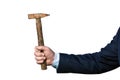 Businessman`s hand in suit holding an old rusty hammer isolated on white Royalty Free Stock Photo