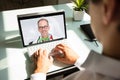 Businessman videoconferencing with doctor on laptop