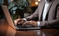 A businessman\'s hands, laptop, and credit card a digital financial transaction in progress