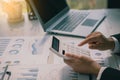 Businessman`s hands pressing a calculator, calculating, analyzing, graphing, charting, accounting worker working on a laptop. A ba