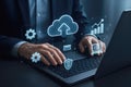 Businessman using laptop with glowing cloud computing and data icons technology Royalty Free Stock Photo