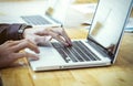 Businessman's hands typing on laptop keyboard.