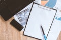 Businessman`s tidy desktop and work tools with paperwork, computer, touch screen devices and stationery on a wooden surface Royalty Free Stock Photo