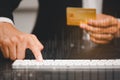 Businessman s using a hand typing keyboard and uses a modern credit card by laptop Royalty Free Stock Photo