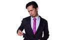 Businessman sad because he ran out of money. Young adult latin young man pulling out empty pocket of his suit jacket Royalty Free Stock Photo