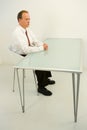 Businessman sat at empty desk