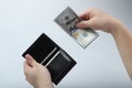 Businessman saving money, Close up man carrying a wallet in hand, the dollar,finance accounting concept