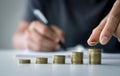 Businessman saving money concept financial. hand holding coins putting on stack. Royalty Free Stock Photo