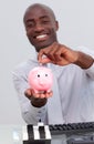 Businessman saving money in a piggybank Royalty Free Stock Photo