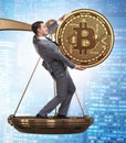 Businessman on scales with bitcoins and other currencies Royalty Free Stock Photo