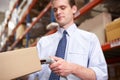 Businessman Scanning Package In Warehouse Royalty Free Stock Photo