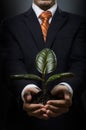 Businessman with scion rubber plant Royalty Free Stock Photo