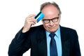 Businessman scratching his forehead with plastic card Royalty Free Stock Photo