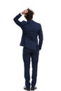 Businessman scratching his head, holding one hand in pocket Royalty Free Stock Photo