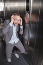 Businessman screaming in the elevator Royalty Free Stock Photo