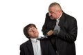 Businessman screaming and fighting at a young colleague Royalty Free Stock Photo