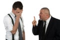 Businessman screaming and fighting at a young colleague Royalty Free Stock Photo