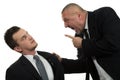 Businessman screaming and fighting at a young colleague Royalty Free Stock Photo