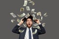 Businessman screaming super excited. Happy young guy celebrating success under money rain falling down dollar bills banknotes Royalty Free Stock Photo