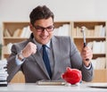 Businessman in search of his savings with piggy bank Royalty Free Stock Photo