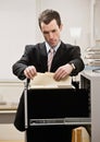 Businessman searches through file drawer Royalty Free Stock Photo