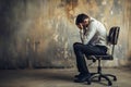 Businessman seated in his chair in frustration and stress