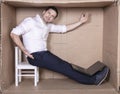 Businessman seated in his cramped office satisfied with his work