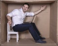 Businessman seated in his cramped office satisfied with his work