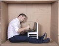 Businessman seated in his cramped office satisfied with his work