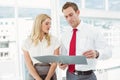 Businessman and secretary looking at file in office